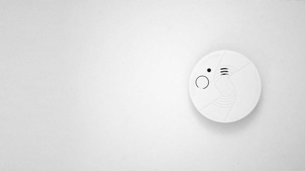 Smoke detector on white ceiling